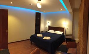 a bedroom with a bed with blue lights on it at Casa Suite in Juliaca