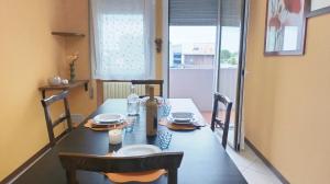 a dining room table with a table and chairs and a window at Dimora Euganea by Ca-Sa Check in Monselice