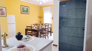 a kitchen and dining room with a table and a glass door at Dimora Euganea by Ca-Sa Check in Monselice +61 photos