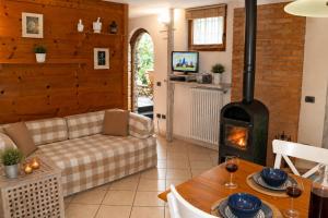 a living room with a couch and a fireplace at Trebbiano Rubicone in Gravedona