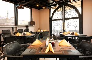 a dining room with tables and chairs and a window at Jade Boutique Hotel in Hanoi