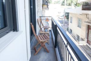 a pair of chairs sitting on a balcony at Brand-New Spacious 3 Bd Apt in Piraeus in Piraeus +39 photos
