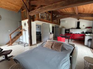 a large bedroom with a bed and a kitchen at Maison à la campagne avec piscine privée et balnéo in Sendets