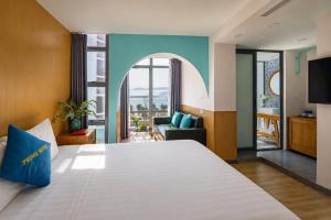 a hotel room with a large bed and a living room at Prime New Hotel in Nha Trang
