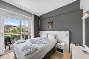 a hotel room with a bed and a window at Mia Casa Hotel in Fethiye