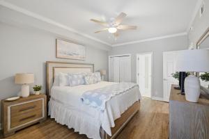 a bedroom with a bed and a ceiling fan at SeaSpray Riverside 112 in Perdido Key +40 photos