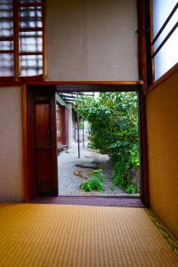 an open door to a garden outside a building at YADOOR名張 -kominka- in Nabari