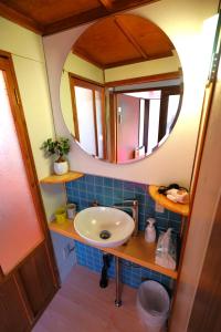 a bathroom with a sink and a mirror at YADOOR名張 -kominka- in Nabari