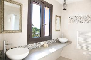 a bathroom with two sinks and a window at Villa Ruzanna in Mandelieu-La Napoule +28 photos