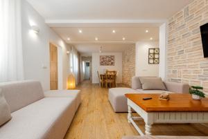 a living room with a couch and a table at Holiday Home Marija with pool in Buković