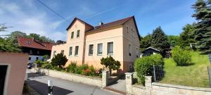 a large house with a fence in front of it at Sandstein-Oase in Reinhardtsdorf