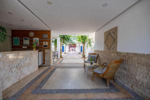 a hallway with chairs and a counter in a building at Ladonia Hotels Zemda in Gümüşlük
