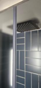 a shelf in a kitchen with blue tiles at Hibiscus Suite - Private Studio Apartment in Rhinebeck Village in Rhinebeck