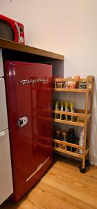 a red refrigerator sitting in a kitchen next to a counter at Hibiscus Suite - Private Studio Apartment in Rhinebeck Village in Rhinebeck +7 photos