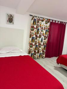 a bedroom with a red bed and a red curtain at Coruche Pool & Jacuzzi Residence - Condomínio Privado in Coruche +42 photos