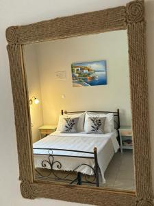 a mirror reflection of a bed in a bedroom at The Olive Studio by Yannula Studios in Kámpos