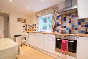 a kitchen with a sink and a stove top oven at South Lodge in Lochgilphead