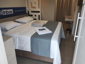 a hotel room with a bed with a towel on it at Hotel In Box - Salvador - Posto HG in Salvador