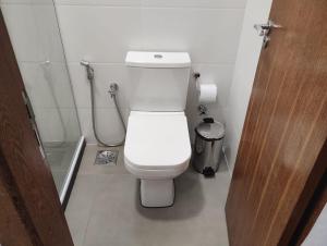 a bathroom with a white toilet and a shower at Hotel In Box - Salvador - Posto HG in Salvador