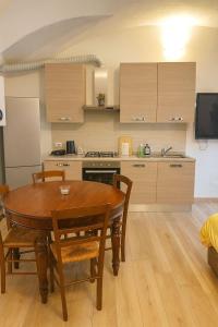 a kitchen and dining room with a table and chairs at Borgo nel Vigneto 1 in Erbusco