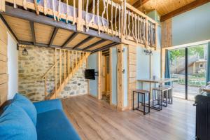 a large living room with a blue couch and a table at Le Cocon - Grospierres in Grospierres