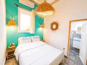 a bedroom with a white bed in a room with green walls at Riad Verus in Fez +96 photos