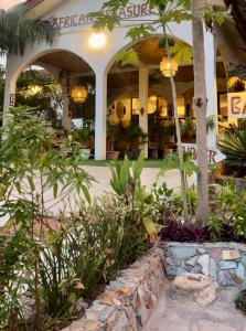 a building with a bunch of plants in front of it at African Treasure kokrobite in Kokrobite