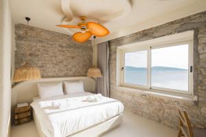 a bedroom with a large bed and a window at YU Townhouse in Bodrum City
