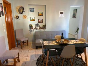 a living room with a table and chairs and a couch at Maria's Apartment in Lixouri