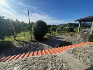 a view of a street with an orange brick fence at Quinta do Eirô in Fonte Arcada