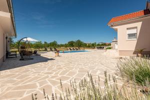 a patio with chairs at Holiday Home Marija with pool in Buković