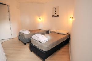 a room with three beds in a room at Posada PuntaDelEste in Punta del Este