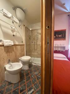 a bathroom with a toilet and a sink and a shower at Hotel Europeo Napoli in Naples +86 photos