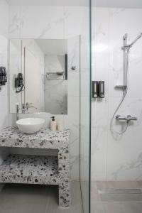 a white bathroom with a sink and a shower at ELYSIAN luxury apartments in Paliouri +30 photos