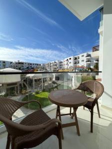 a balcony with a table and chairs and a view of a city at Jasmine Resort Complex in Sharm El Sheikh
