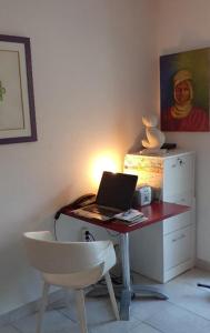 a desk with a laptop on a table with a chair at Plouf in Saint-Hilaire-de-Riez