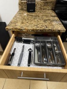 a drawer in a kitchen with utensils at Luxury Apartment with Ocean Views in Fajardo