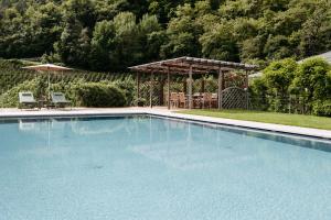 a large swimming pool with a gazebo at Untermairhof in Lagundo
