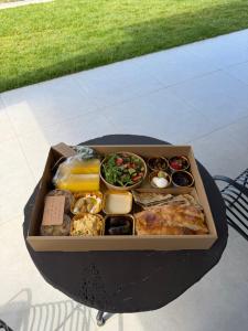 a box of food sitting on a table at Calma Hermon Guest Rooms in Neve Ativ