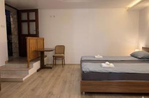 a bedroom with a bed and a table and a chair at Danilo Room 1 in Pula