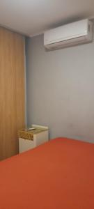 a room with a red table and a heater at La quinta de Hostal in Rosario