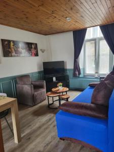 a living room with a couch and a table at Marx Motel in Valkenburg
