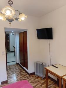 a living room with a flat screen tv on the wall at Hotel guido palace in Buenos Aires