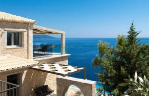 a view of the ocean from the balcony of a house at White Orchid in Syvota