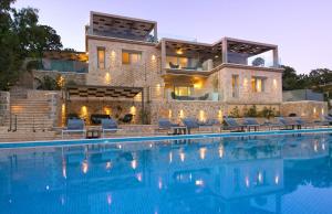a house with a swimming pool in front of a house at White Orchid in Syvota