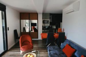 a living room with a couch and chairs and a table at Appartements Mistral in Pyla-sur-Mer