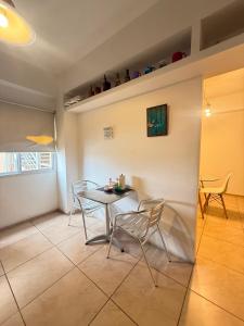 a dining room with a table and chairs at General Acha 869 in San Juan