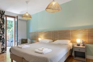 a bedroom with a large bed with two towels on it at Bc Garda House in Peschiera del Garda