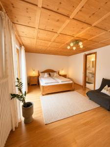 a bedroom with a bed and a wooden ceiling at Faneskla Apartments in Silbertal +93 photos