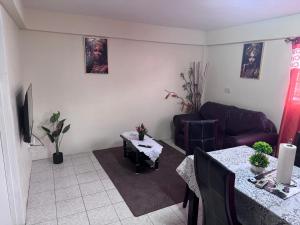a living room with a couch and a table at Mountain View Apartments in Gros Islet +2 photos